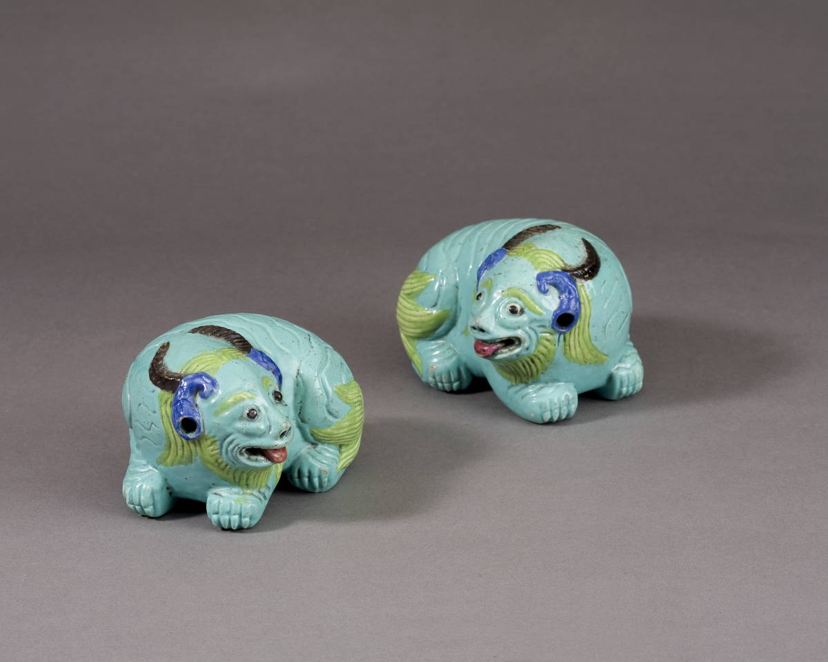 Appraisal: PAIR OF CHINESE EXPORT PORCELAIN TURQUOISE-GROUND FIGURES OF MYTHOLOGICAL BEASTS