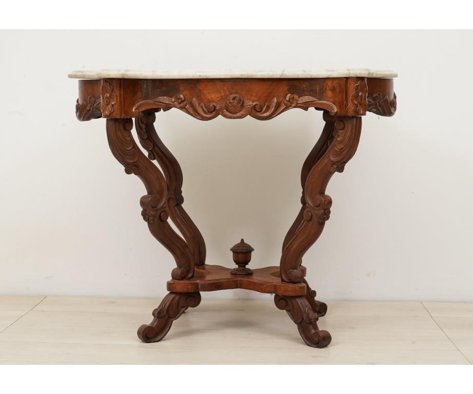 Appraisal: Victorian walnut carved parlor table with shaped turtle top h