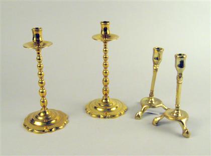 Appraisal: Two pairs of Continental brass candlesticks th century The first