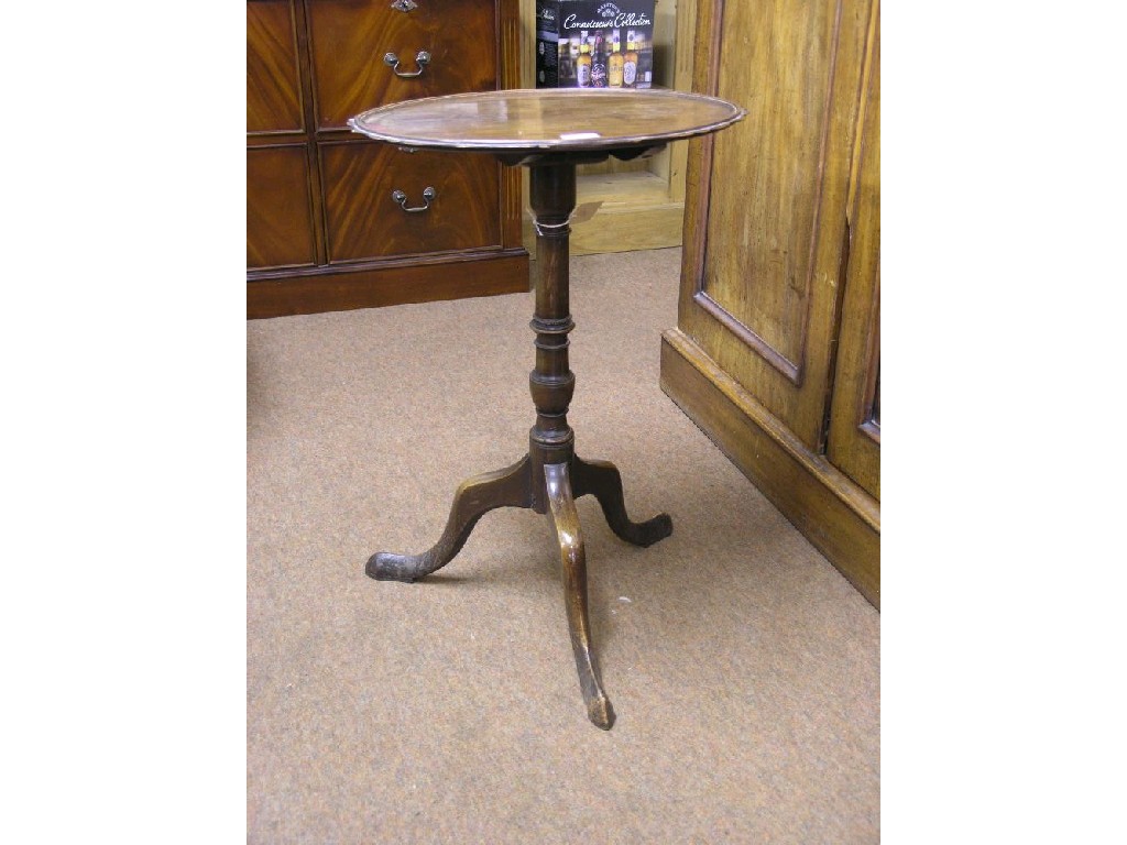 Appraisal: A late Victorian mahogany tilt-top tripod table with carved rim