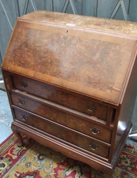 Appraisal: A mid th century burr walnut bureau the fall enclosing