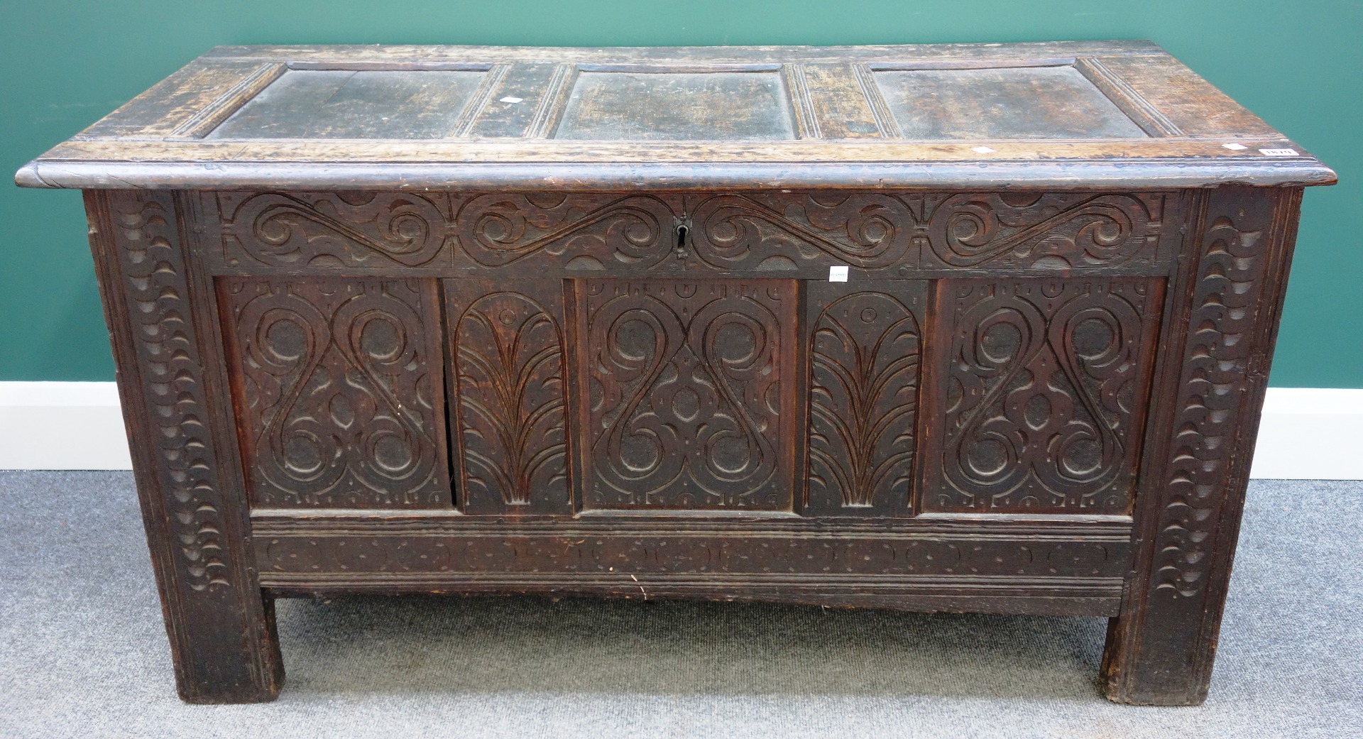 Appraisal: A th century carved oak coffer with triple panel lid