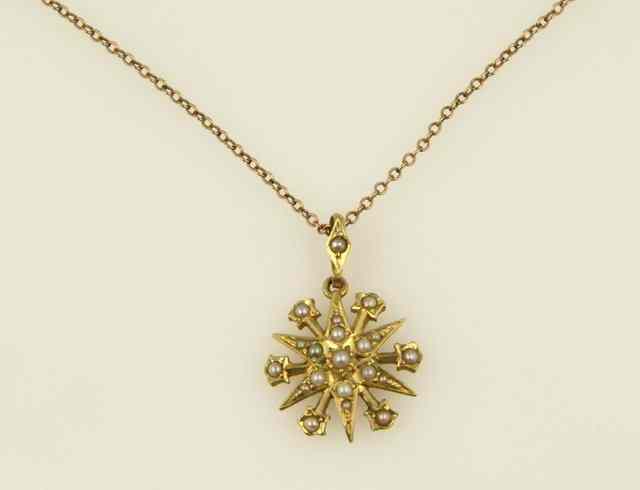 Appraisal: A seed pearl starburst pendant in a ct gold setting