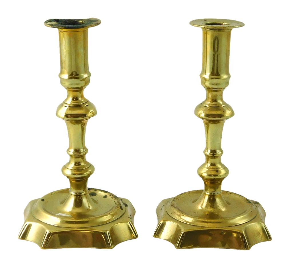 Appraisal: Pair of seamed brass candlesticks English Circa cut corner bases