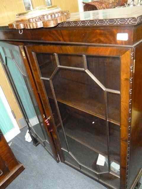 Appraisal: A MAHOGANY BOOKCASE the astragal glazed doors enclosing adjustable shelves