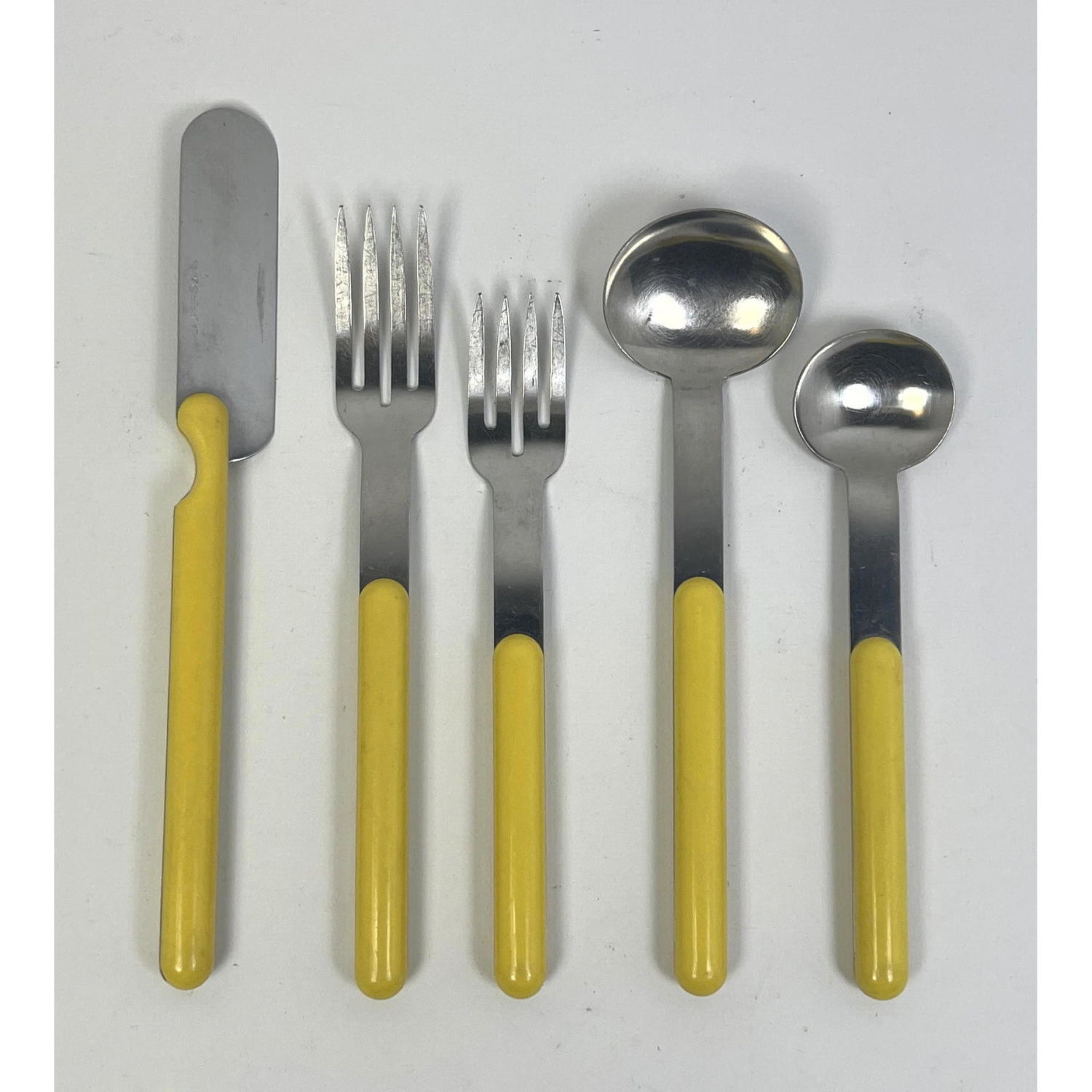 Appraisal: LAUFFER Yellow Handled Stainless Modernist Flatware Service for pieces Dimensions