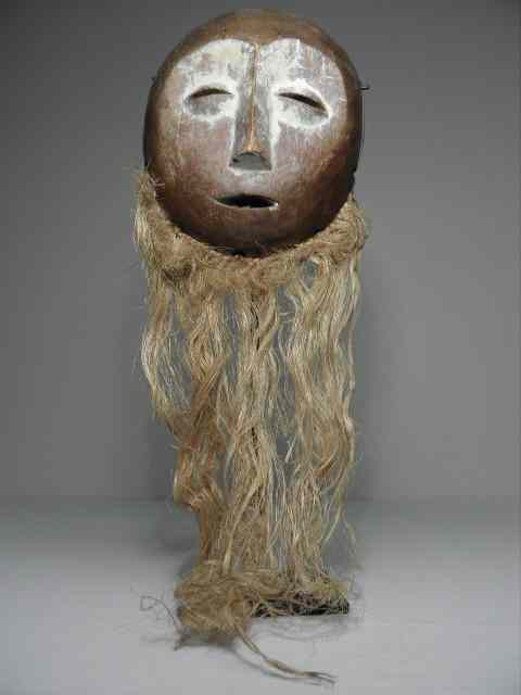 Appraisal: African carved wood tribal mask White highlights and straw additions