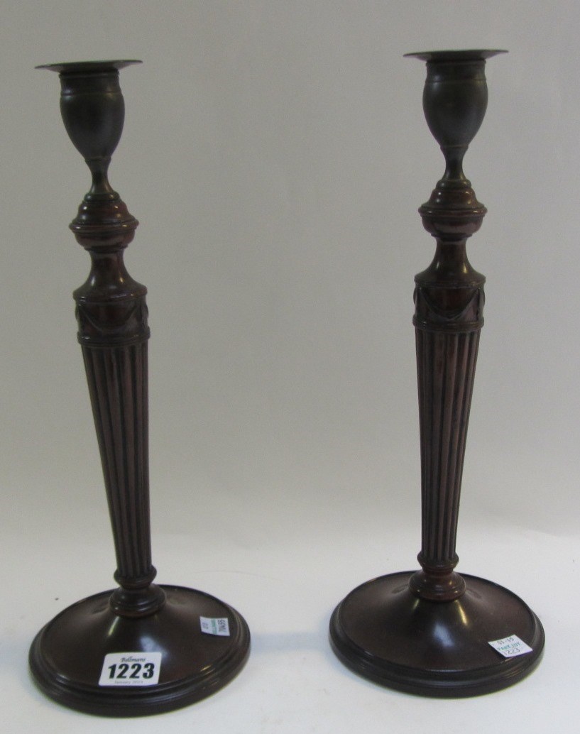 Appraisal: A pair of early th century mahogany candlesticks with reeded