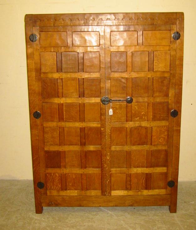 Appraisal: AN OAK WARDROBE by Robert Mouseman Thompson of oblong multi