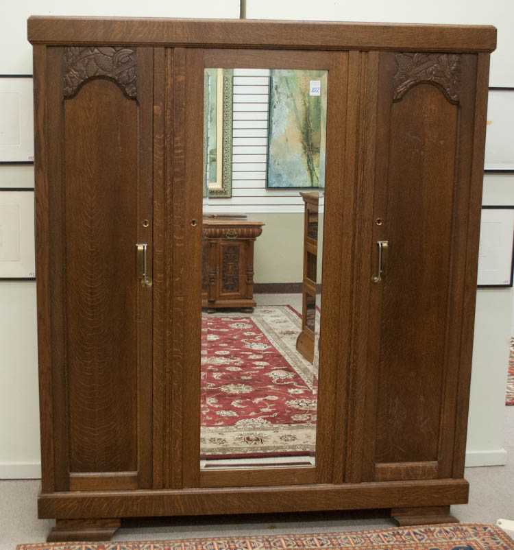 Appraisal: THREE-DOOR OAK WARDROBE Belgian c the front centering a mirror