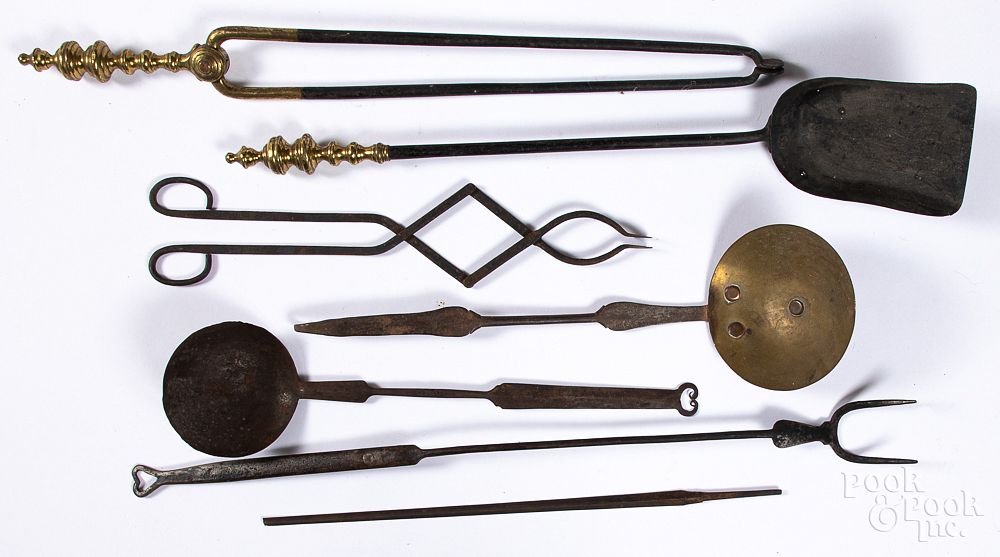 Appraisal: Wrought iron and brass utensils fireplace tools Wrought iron and