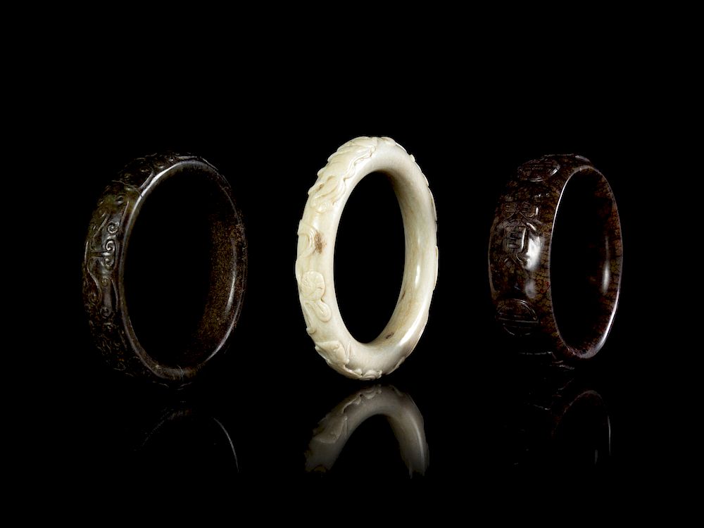 Appraisal: Three Carved Hardstone Bangles Largest diam diam in cm Three