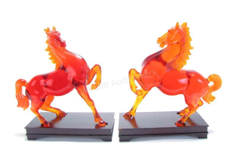 Appraisal: Pair of Cherry Amber Horse figures single hoof raised pose