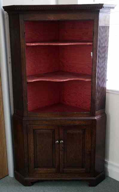 Appraisal: A late th Century oak floor standing corner cupboard the