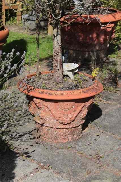 Appraisal: A PAIR OF TERRACOTTA PLANT POTS decorated with fawn masks