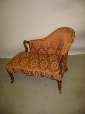 Appraisal: A VICTORIAN WALNUT FRAMED CANAPE upholstered in salmon tapestry covering