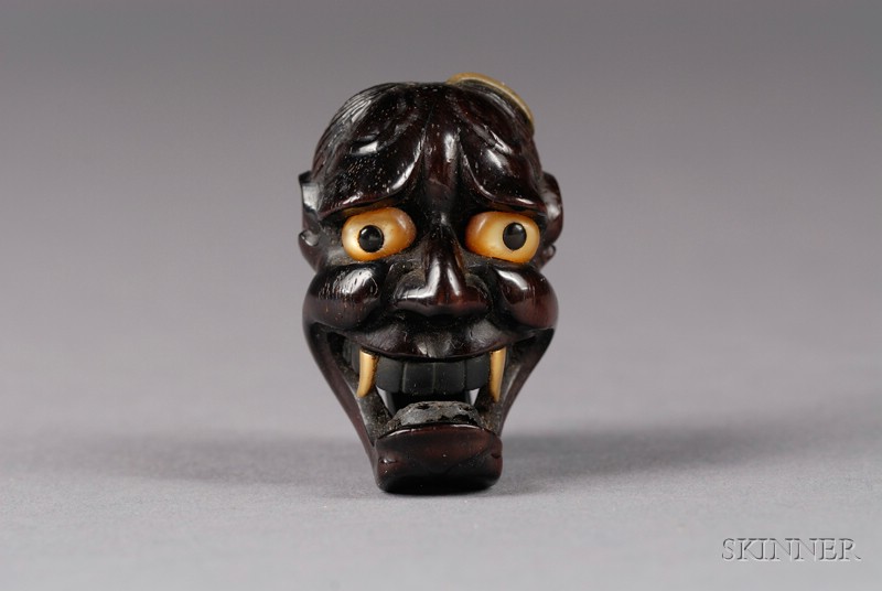 Appraisal: Demon Mask Netsuke carved hardwood with horn and mother-of-pearl inlay