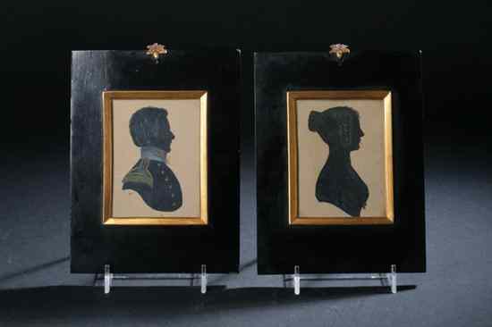 Appraisal: PAIR ENGLISH CUT AND PAINTED PAPER SILHOUETTES Circa Each highlighted