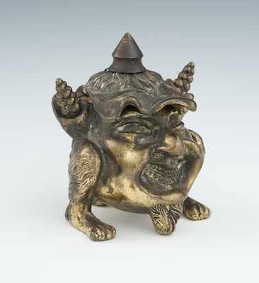 Appraisal: A Grotesque Figural Cigar Lighter Grinning face with animal feet