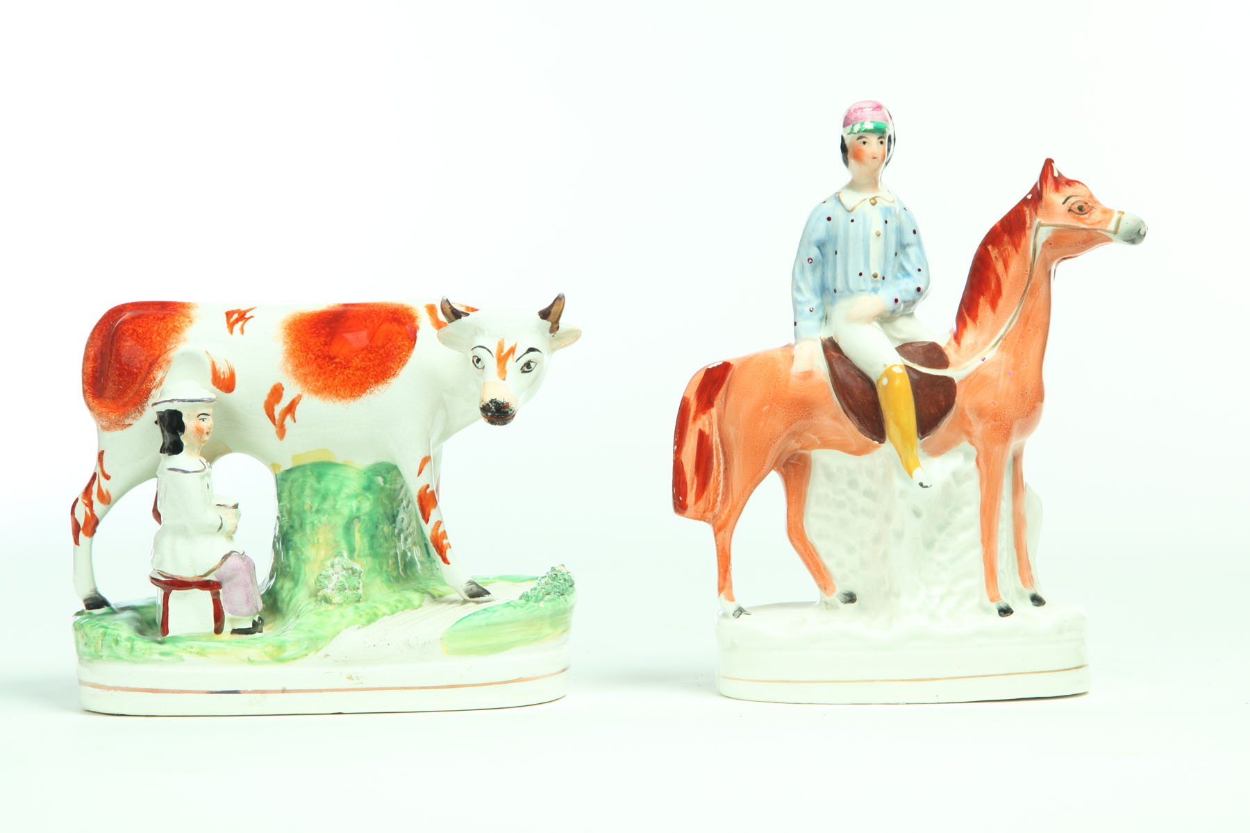 Appraisal: TWO STAFFORDSHIRE FIGURINES England nd half- th century Cow and