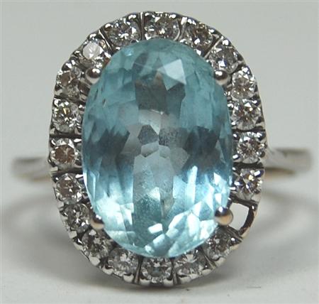 Appraisal: An aquamarine and diamond oval cluster ring the central claw