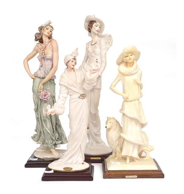 Appraisal: THREE GIUSEPPE ARMANI FASHION FIGURES AND ONE OTHER RESIN FIGURE