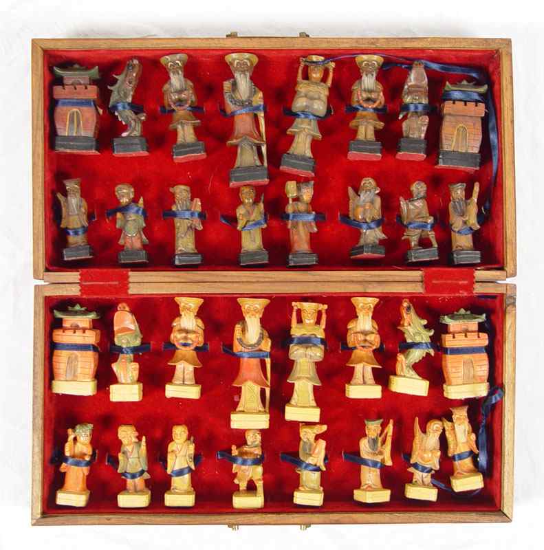 Appraisal: AN UNUSUAL CARVED WOOD CHINESE FIGURAL CHESS SET IN CASE