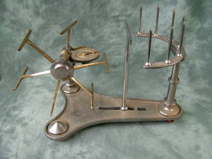 Appraisal: A polished steel and brass table top wool winder with