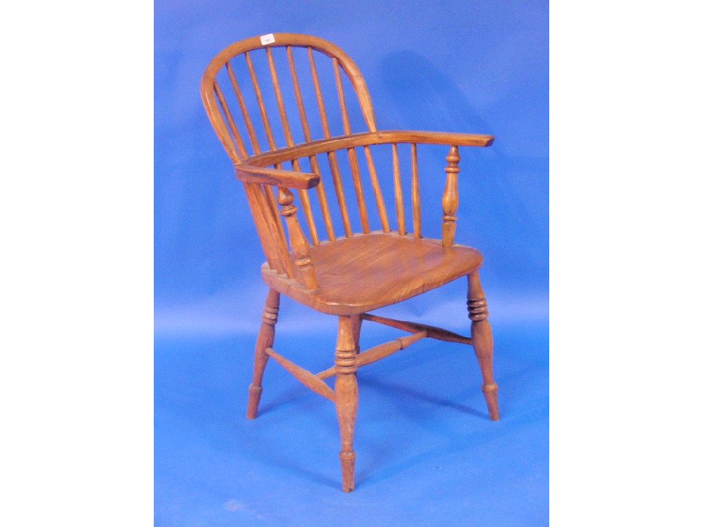 Appraisal: An elm and ash Windsor chair with spindle back on