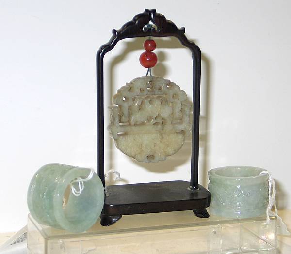 Appraisal: Three jade carvings Including a circular nephrite reticulated pendent in