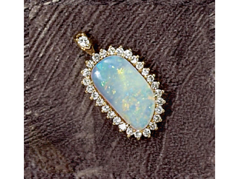 Appraisal: OPAL AND DIAMOND PENDANT k yellow gold pendant with modified