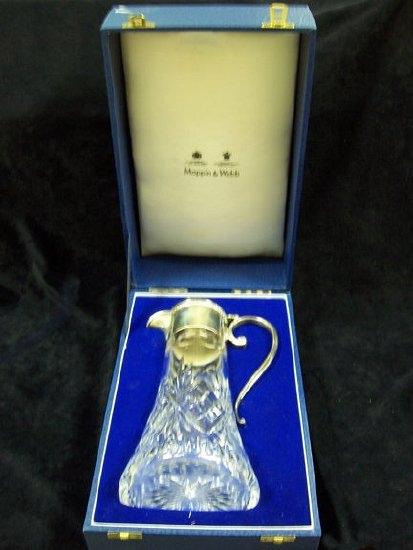 Appraisal: A silver mounted cut glass claret jug with scroll handle