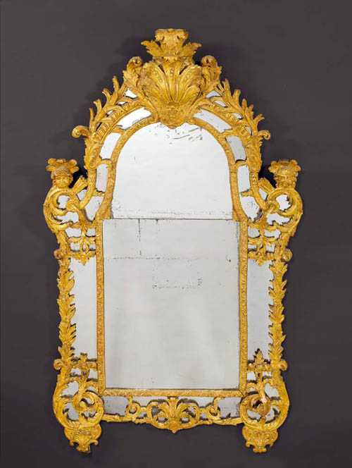 Appraisal: CARVED GILTWOOD MIRROR AUX BUSTES D'INDIENS R gence Paris circa