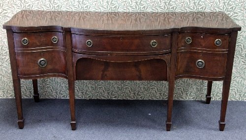 Appraisal: A mahogany serpentine front sideboard fitted drawers and a cellaret