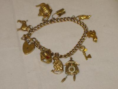 Appraisal: A CT GOLD CHARM BRACELET the flattened curb link with