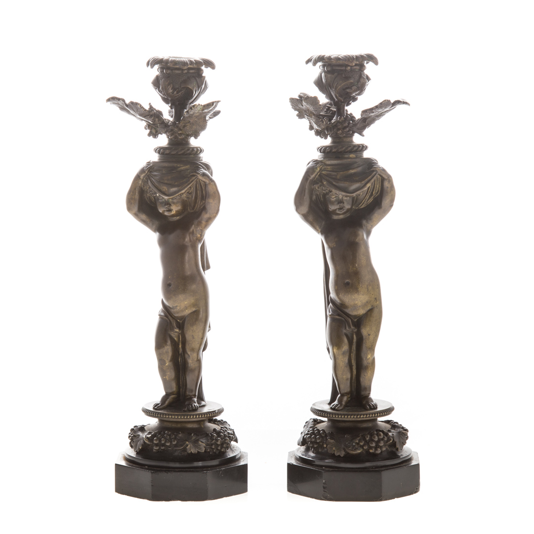 Appraisal: Pair of bronze putti candlesticks late th century each figure