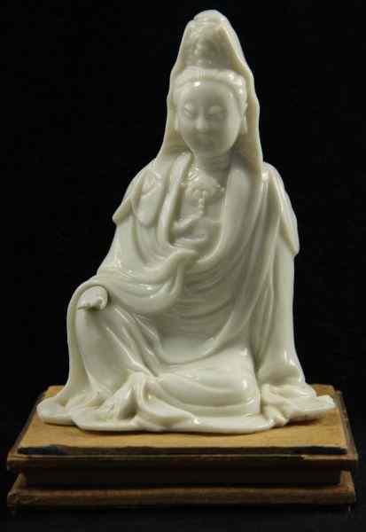 Appraisal: Blanc-de-Chine Guanyinpossibly th century the seated figure with wood stand