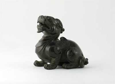 Appraisal: A Chinese bronze model of a crouching horned lion dog