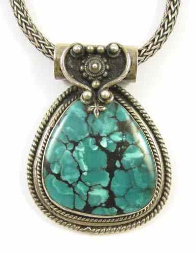 Appraisal: A HEAVY STERLING SILVER MOUNTED TURQUOISE PENDANT in matrix heart-shaped