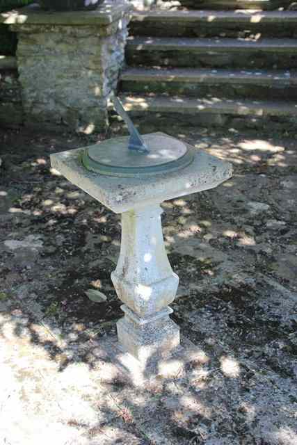 Appraisal: A RECONSTITUTED STONE SUN DIAL with circular bronze dial mounted