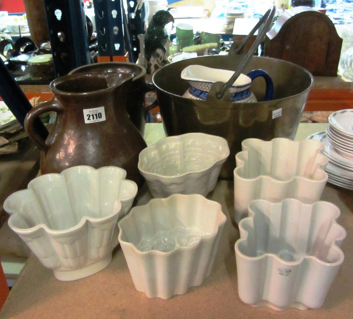 Appraisal: Two stoneware jugs five ceramic jelly moulds and a brass