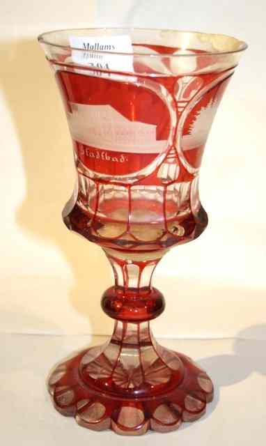 Appraisal: A BOHEMIAN CRANBERRY GLASS GOBLET the trumpet shaped bowl etched