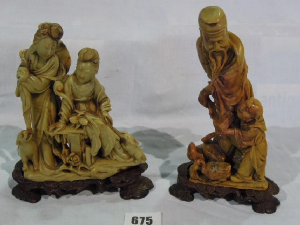 Appraisal: Two well carved soapstone groups family figures with animals