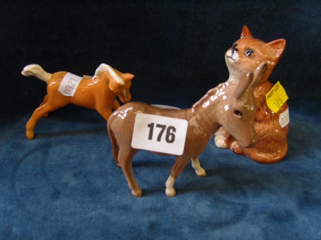 Appraisal: A Beswick donkey a Beswick Palomino foal and a Beswick