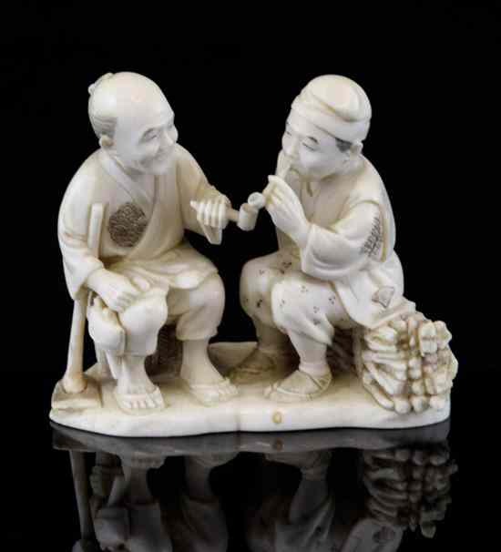 Appraisal: A Japanese ivory group of two seated men smoking pipes