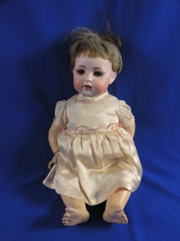 Appraisal: A German bisque head doll with a short blond wig