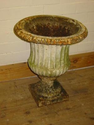 Appraisal: A PAIR OF VICTORIAN CAST IRON GARDEN URNS of fluted