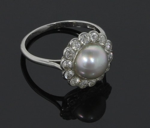 Appraisal: A pearl and diamond cluster ring the central pearl to