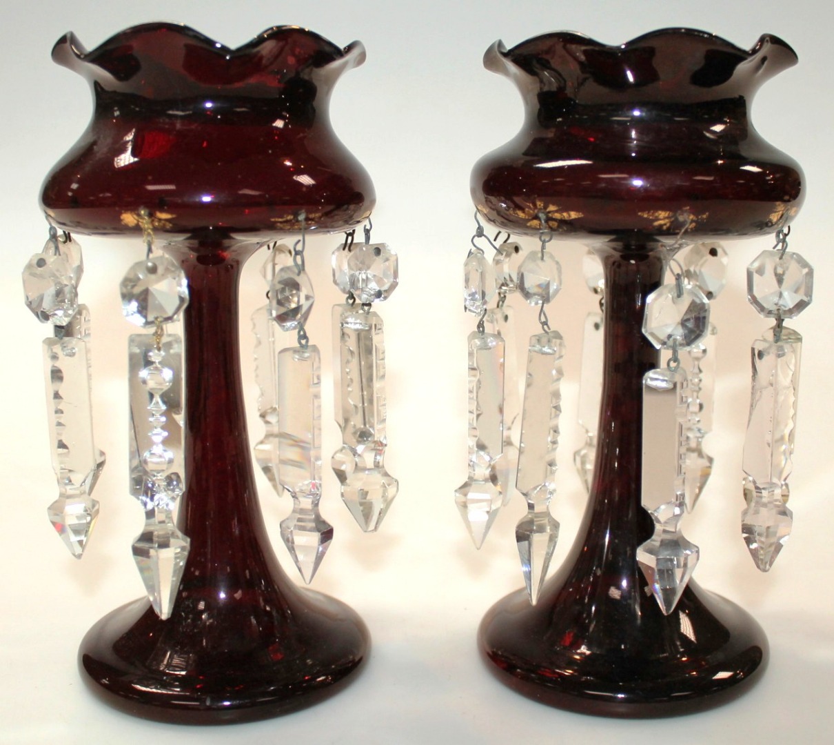 Appraisal: A pair of Edwardian ruby glass lustres each with floral