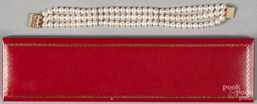 Appraisal: Three strand pearl bracelet with K gold clasp Three strand